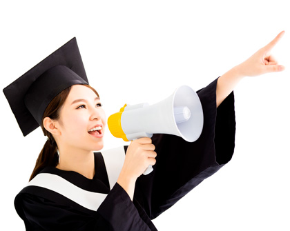 woman wearing graduation cap and gown pointing with megaphone